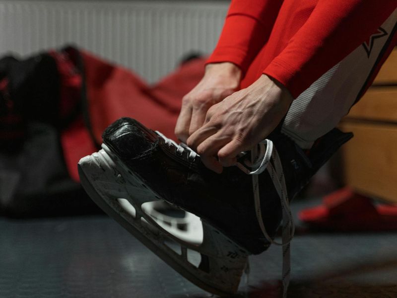 Close up of sports equipment and a woman's hands preparing for a session